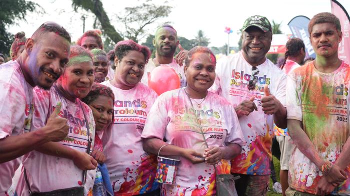 Colour run participants covered in pink powder