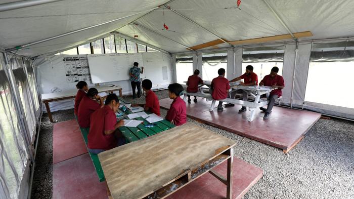Students in a temporary classroom tent