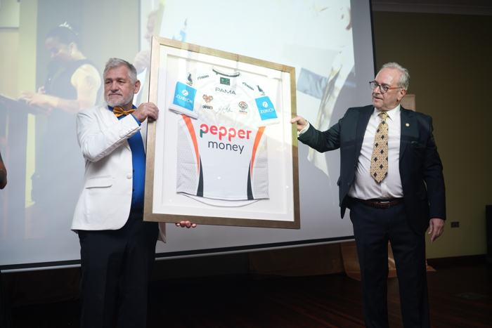 Presentation of a framed signed jersey on stage