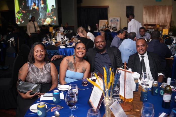 Guests smiling at a dinner table