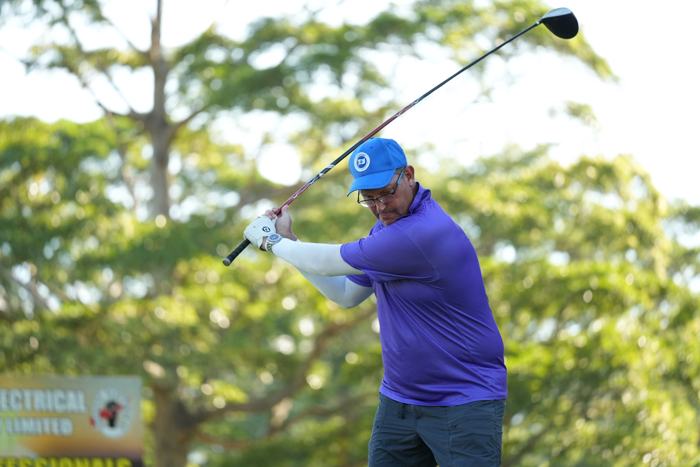 Golfer mid-swing at a corporate golf day