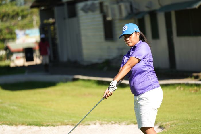 Golfer teeing off