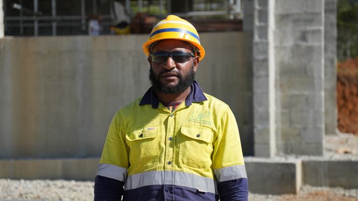 Site worker in hard hat and high-visibility shirt