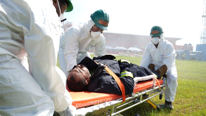 Responders carrying a casualty on a stretcher