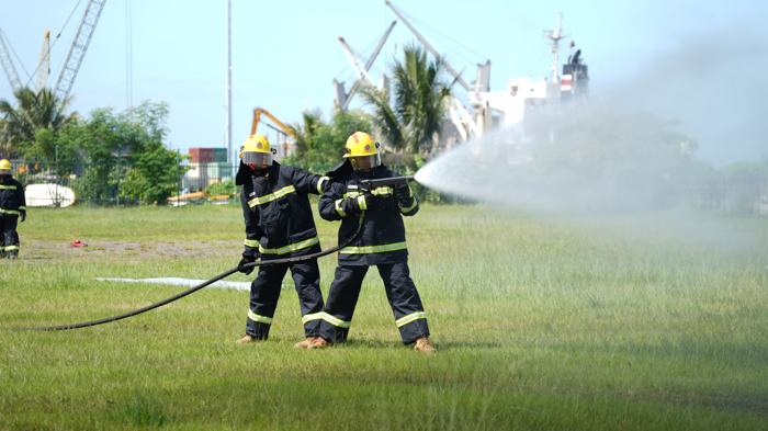 Firefighters operating a hose