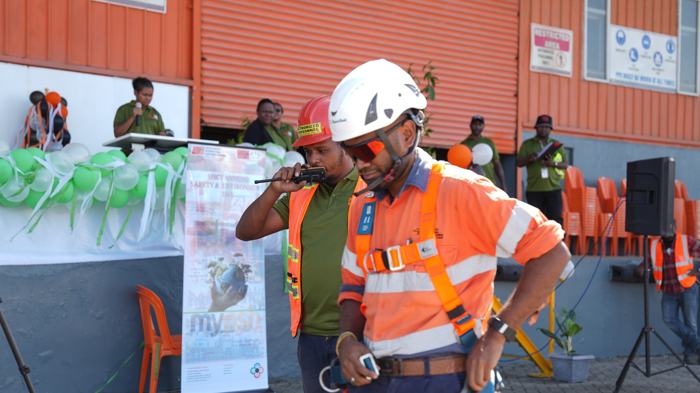 Safety officer speaking to workers