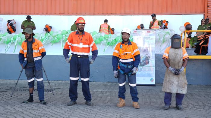 Workers demonstrating protective equipment