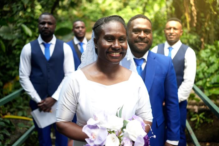 Bride smiling with the groomsmen